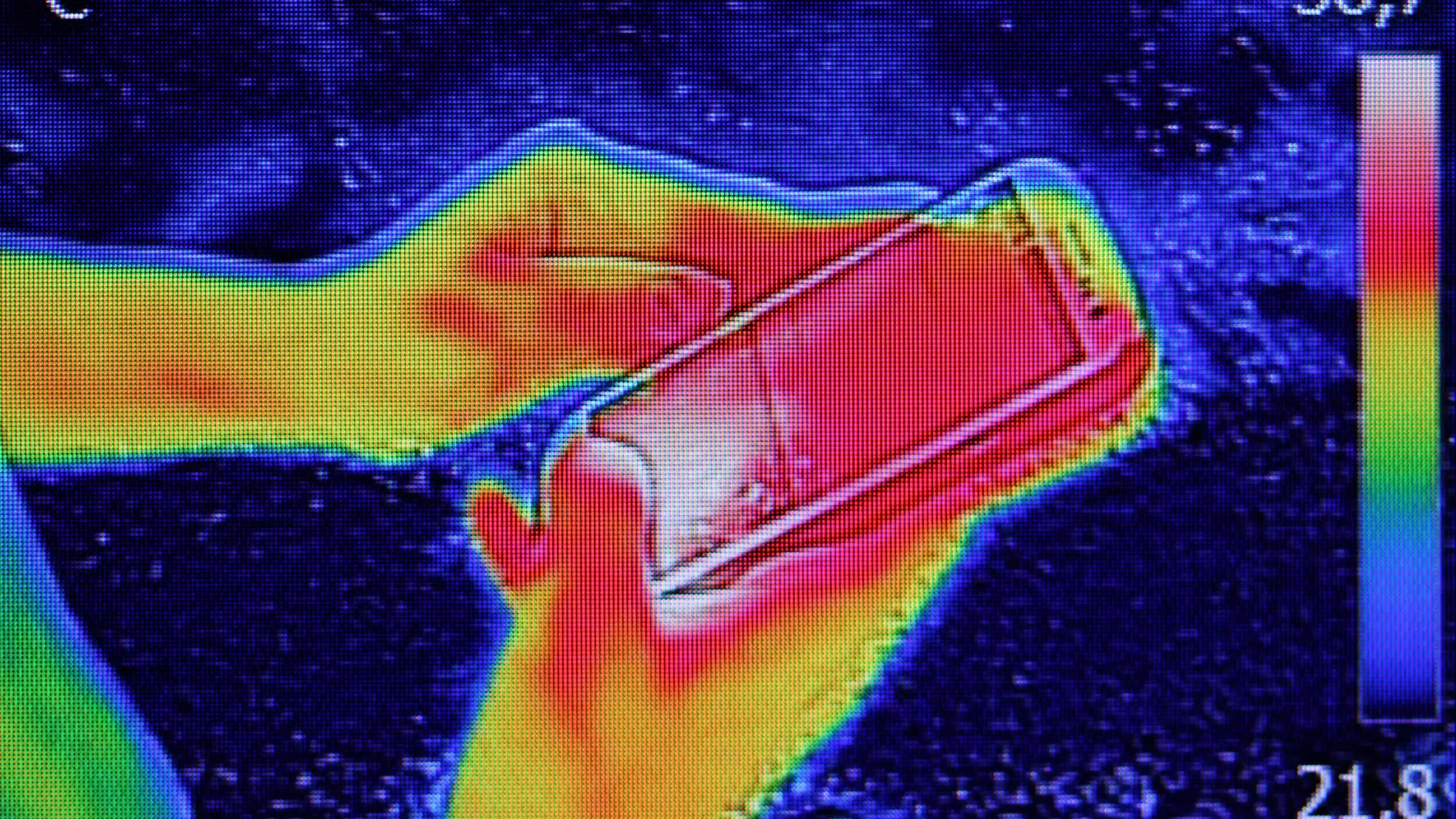 Infrared thermography image showing the heat emission when Young girl used smartphone or cell phone
