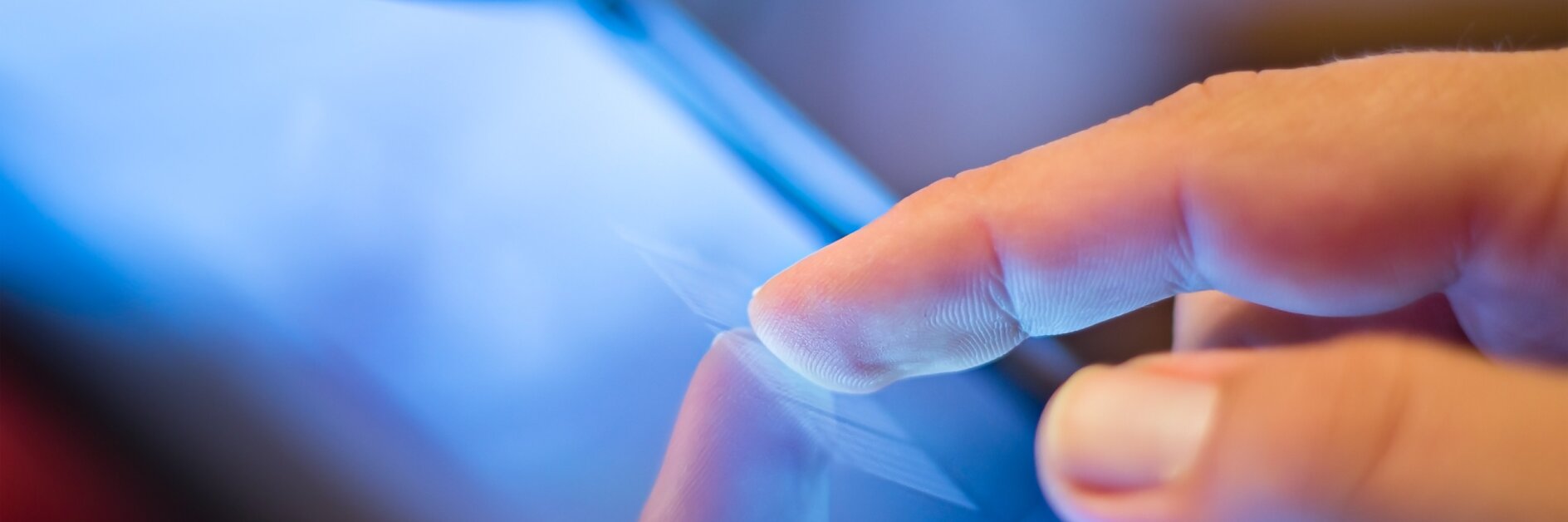 closeup of finger touching screen on tablet-pc with shallow depth of field