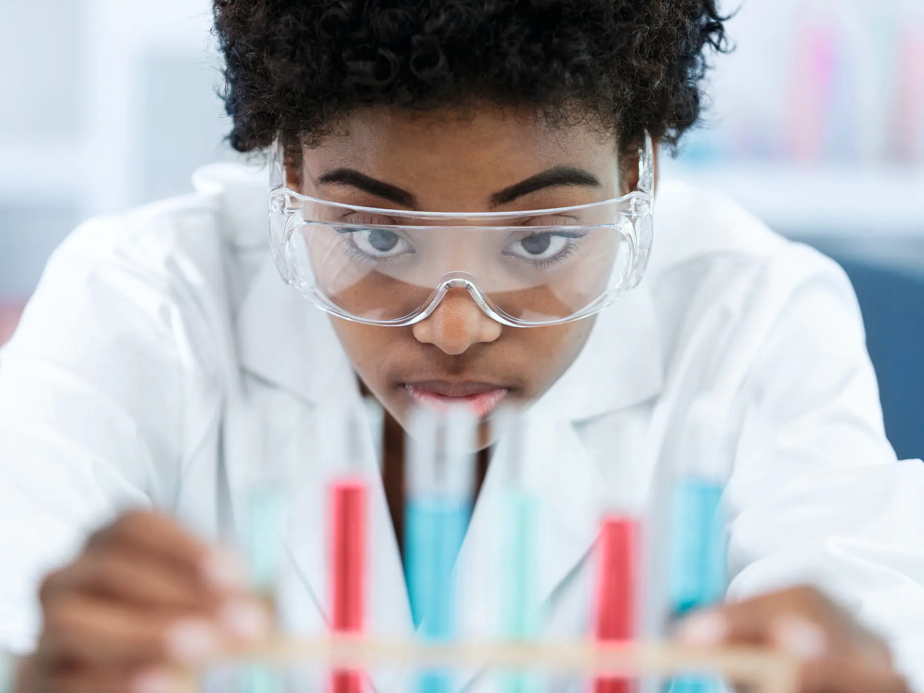 woman with glasses holds samples in her hands