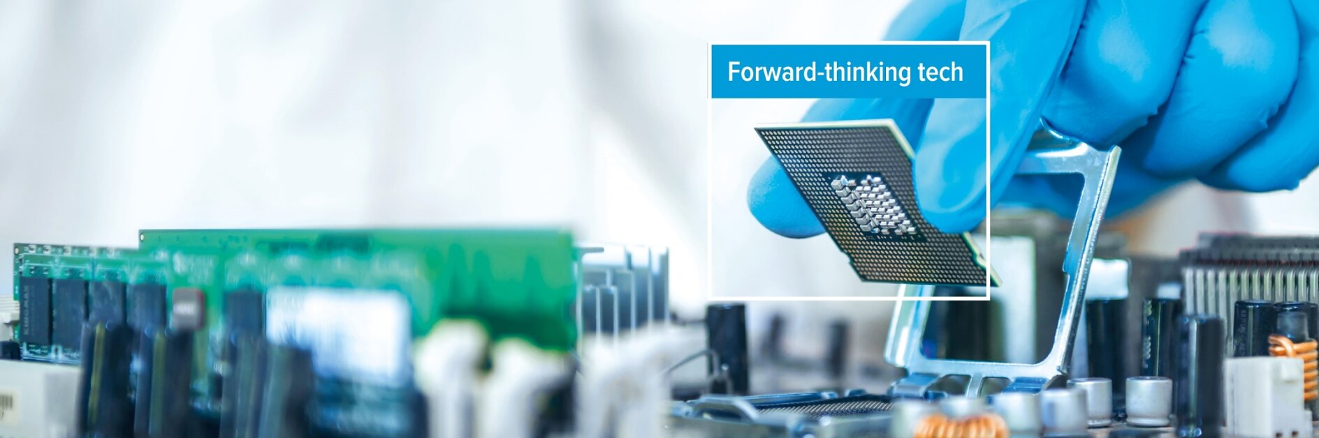 A person wearing a blue glove installs a computer processor onto a motherboard using tesa tape. The phrase Forward-thinking tech appears over the processor.